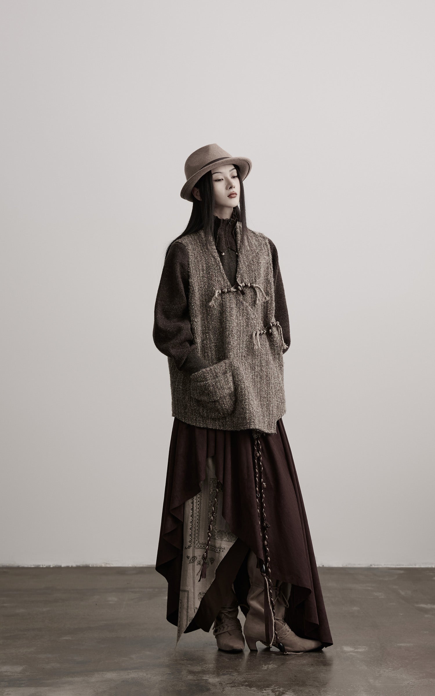DOINDULGE Textured Wool Vest with Asymmetric Panels and Hand-Tied Toggle Details
