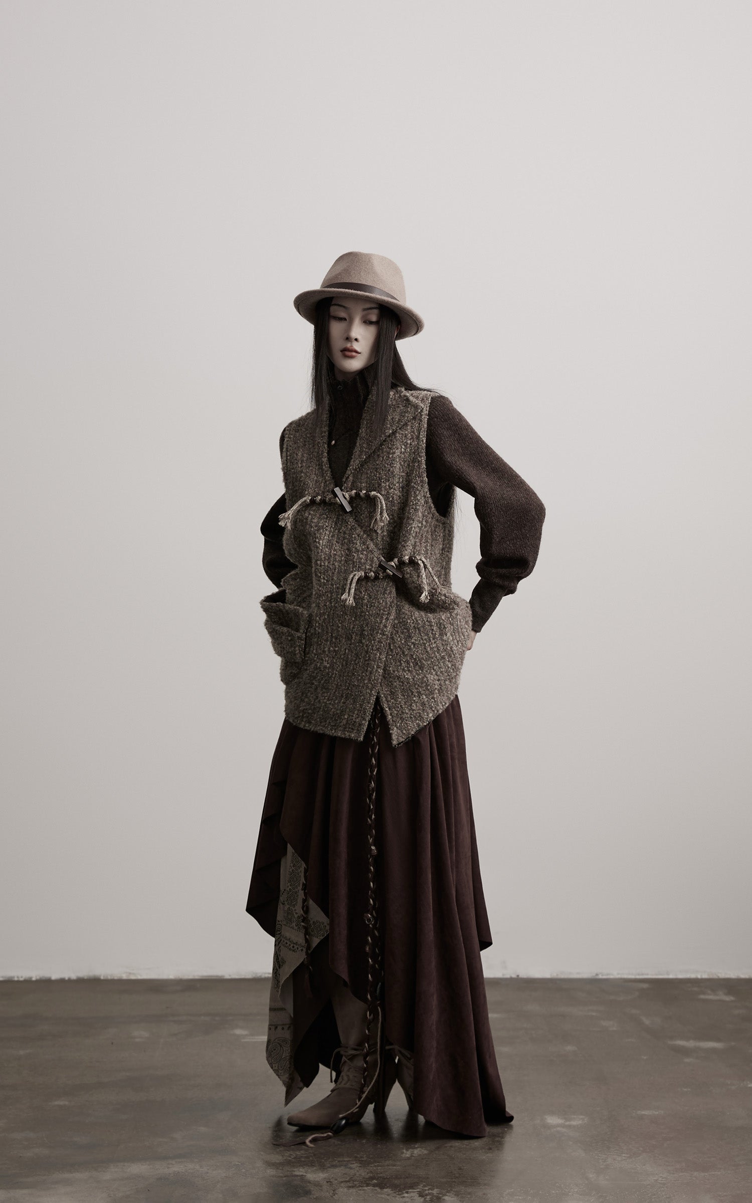 DOINDULGE Textured Wool Vest with Asymmetric Panels and Hand-Tied Toggle Details