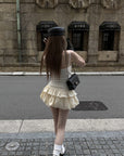 Rase le sol Cream Layered Ruffle Bubble Mini Skirt With Cross-Wing Appliqué