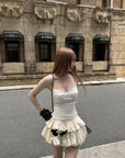Rase le sol Cream Layered Ruffle Bubble Mini Skirt With Cross-Wing Appliqué