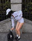 ROVENTE Cropped Zip Jacket and Mini Shorts Set with Embroidered Script Detail and Relaxed Sporty Silhouette