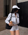 ROVENTE Cropped Zip Jacket and Mini Shorts Set with Embroidered Script Detail and Relaxed Sporty Silhouette