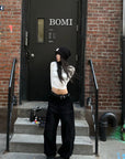WARDEN EDGE Washed Black Corduroy Wide-Leg Pants with Curved Silhouette & Faded Whisker Detail