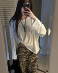 Rase le sol Amor Fati Cross-Embroidered Asymmetric Draped Long Sleeve Top