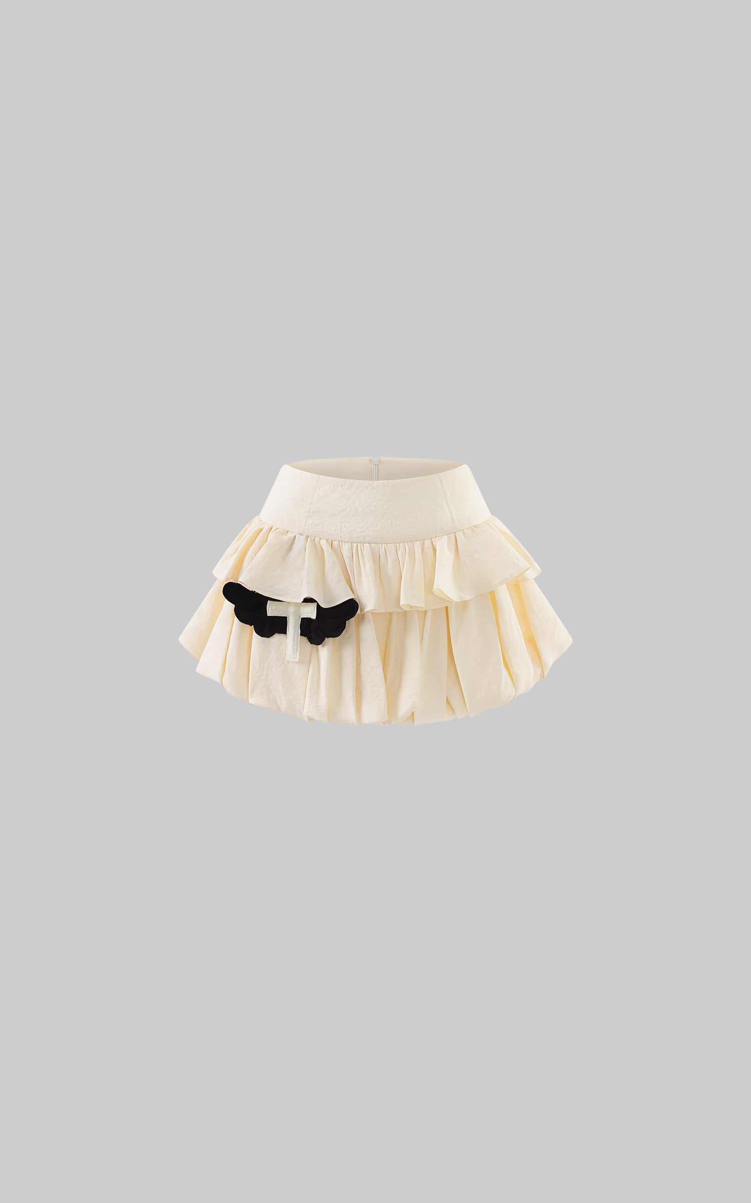 Rase le sol Cream Layered Ruffle Bubble Mini Skirt With Cross-Wing Appliqué
