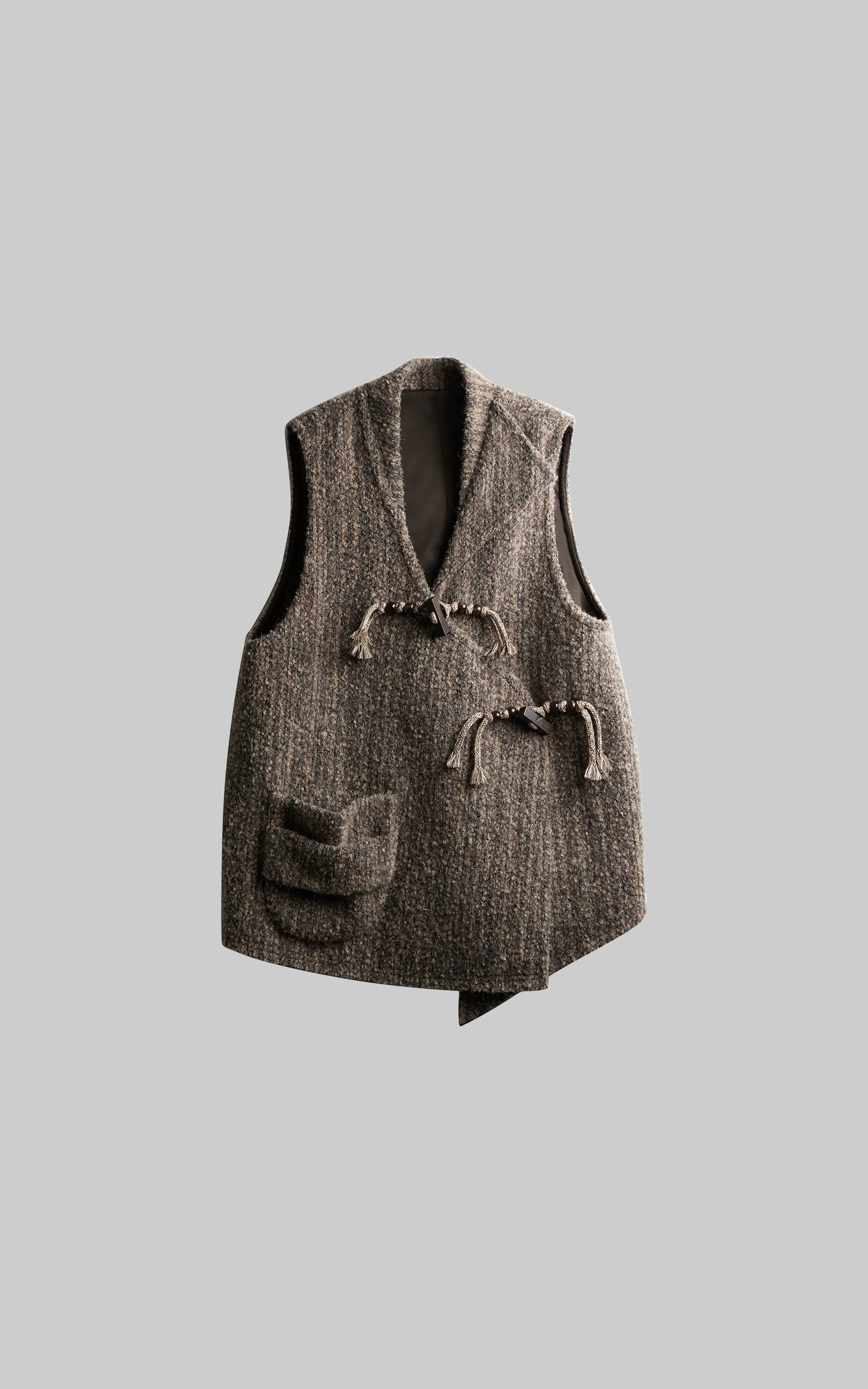 DOINDULGE Textured Wool Vest with Asymmetric Panels and Hand-Tied Toggle Details