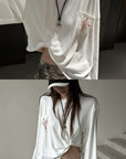 Rase le sol Amor Fati Cross-Embroidered Asymmetric Draped Long Sleeve Top