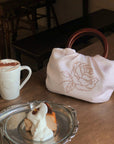 Hydrae Rhinestone Rose Satin Mini Handbag with Sculptural Wooden Ring Handles
